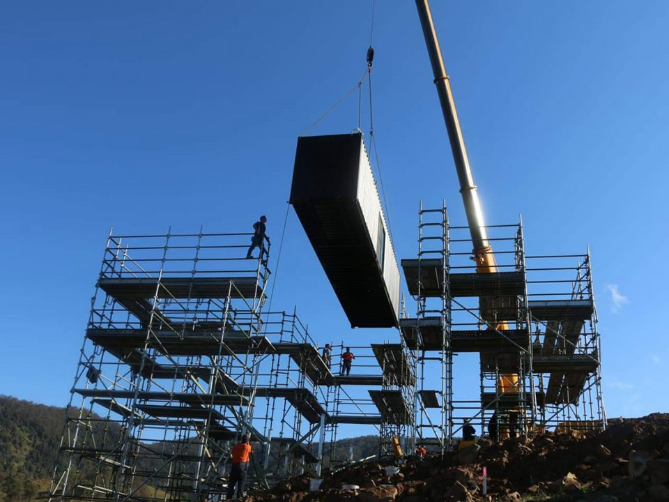 Moving containers into position. Source: The New Daily