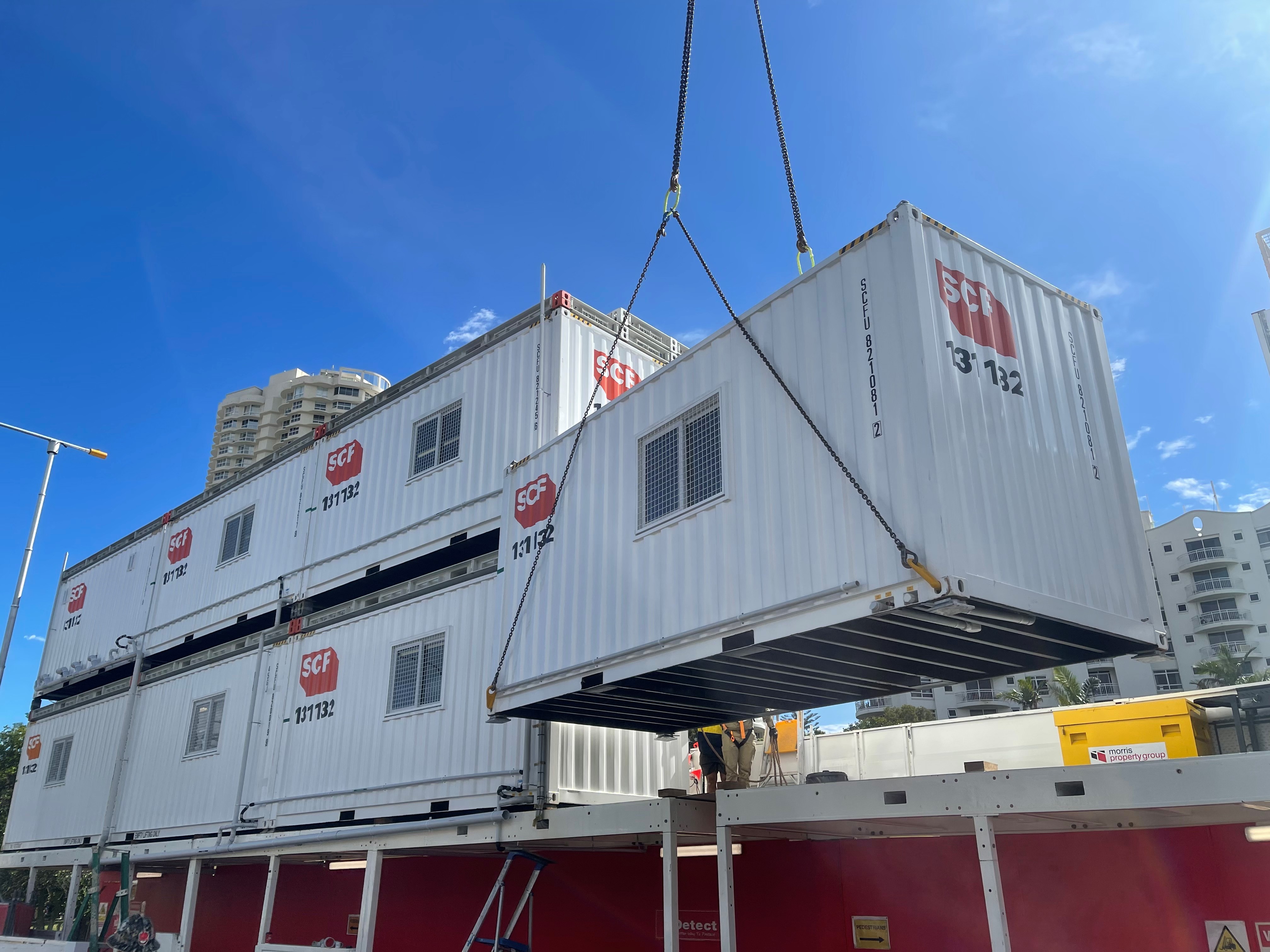 Crane lifting a 20ft Site Shed on to a gantry.