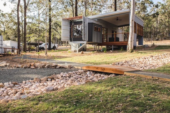 Modify a shipping container to include a raised roof and large windows. Source: AirBnB, New South Wales, Australia.